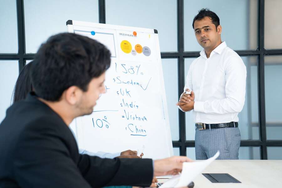 pensive-indian-business-trainer-listening-audience-questions-after-presentation_1262-12810